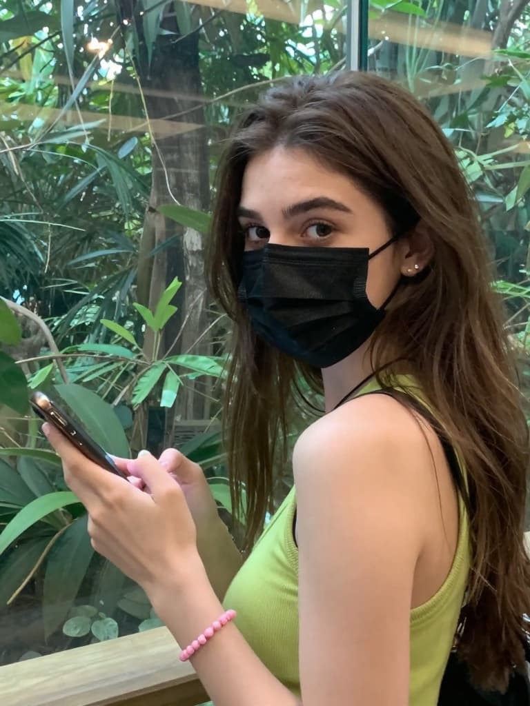 Smartphone photo taken by a friend of a young caucasian woman with…
