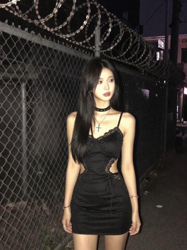 Candid-style nighttime smartphone photo of a beautiful young East…