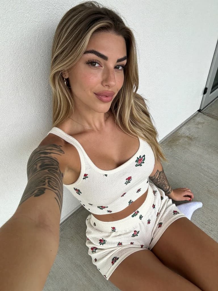 Smartphone selfie of a conventionally attractive young woman in her…