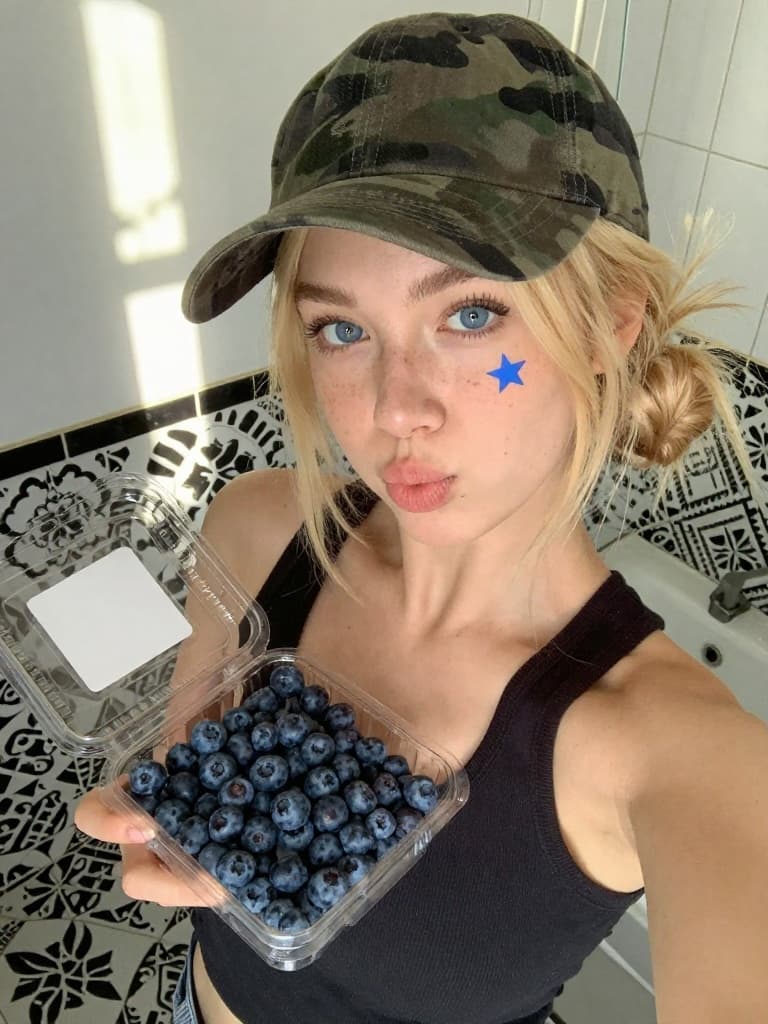 Smartphone selfie of a young caucasian woman with blonde hair in a…