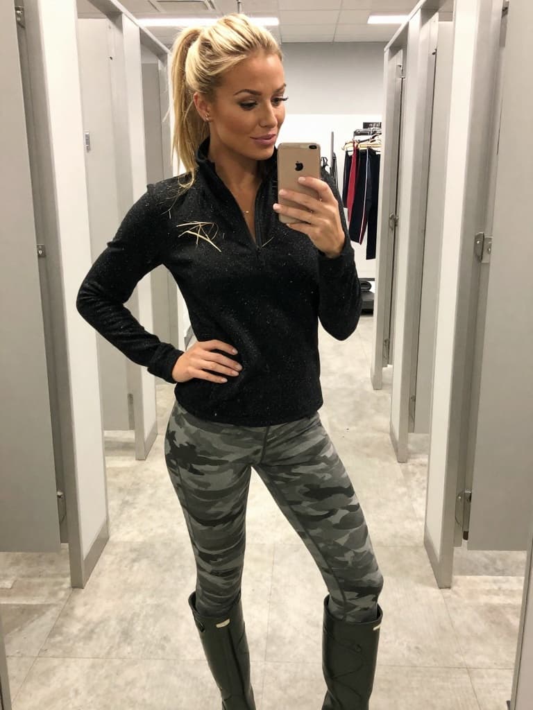 IPhone mirror selfie of a conventionally attractive young blonde…