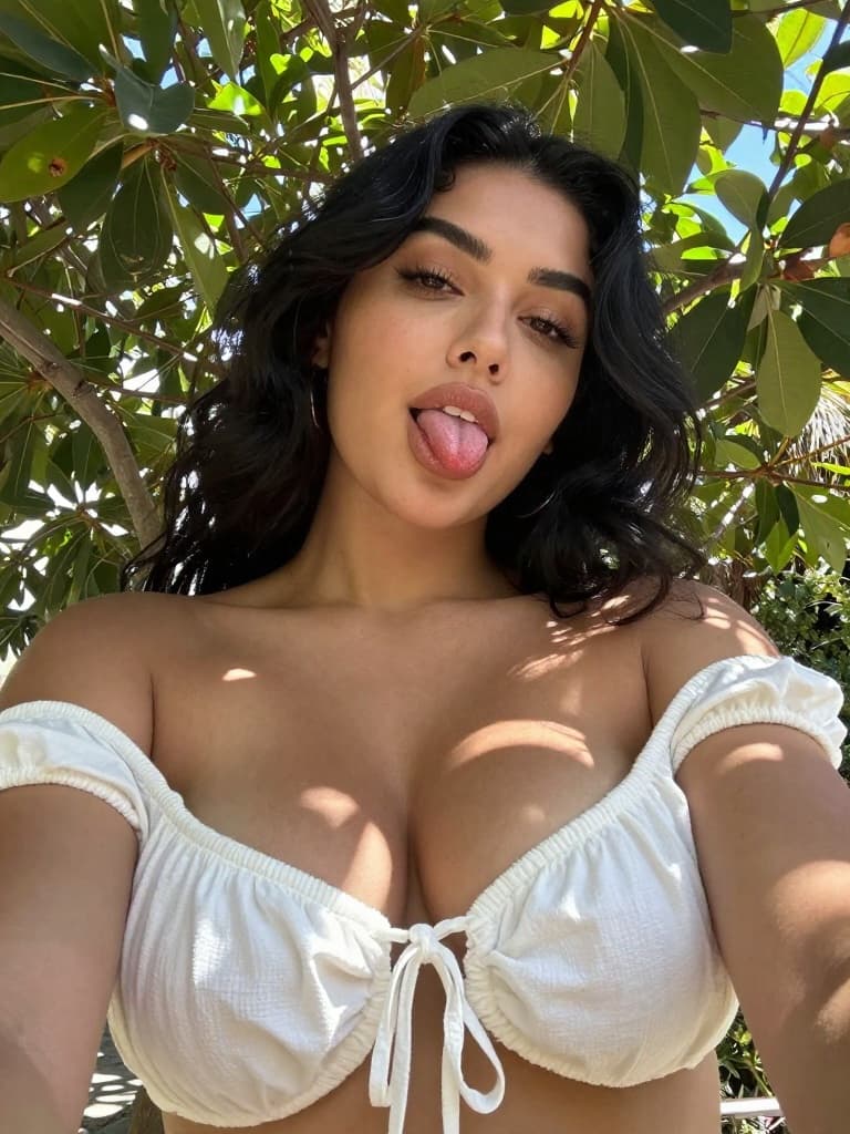 Selfie taken on a modern smartphone by a curvy young Hispanic woman…