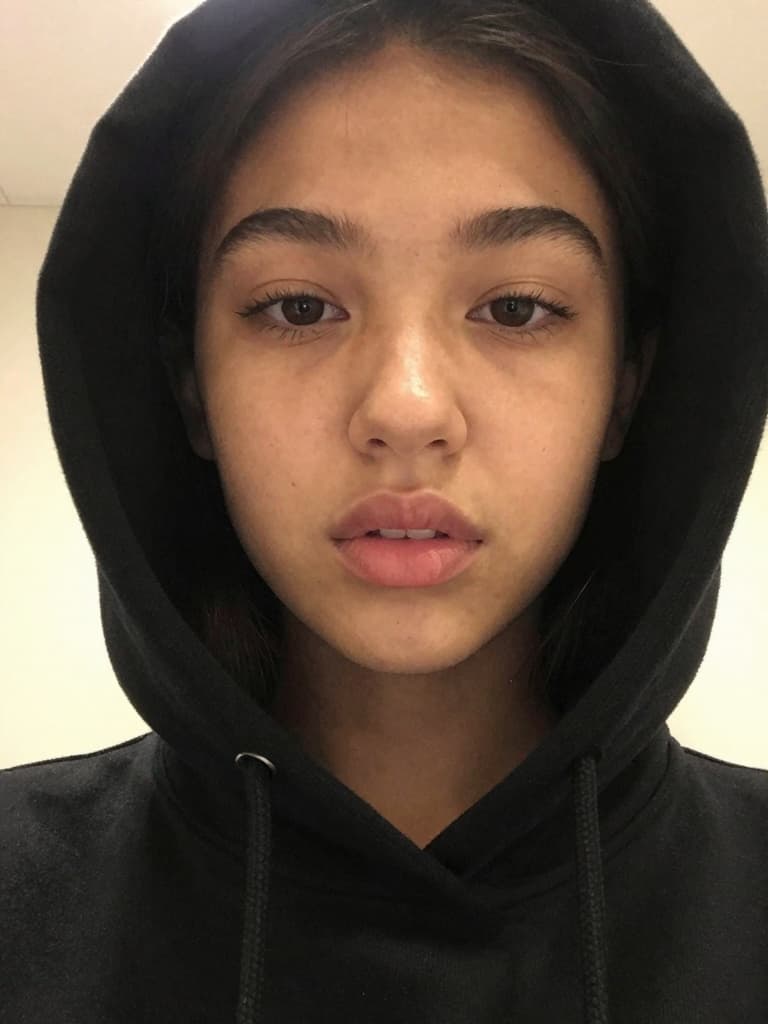 Smartphone selfie of a beautiful teenage girl with tanned skin and…