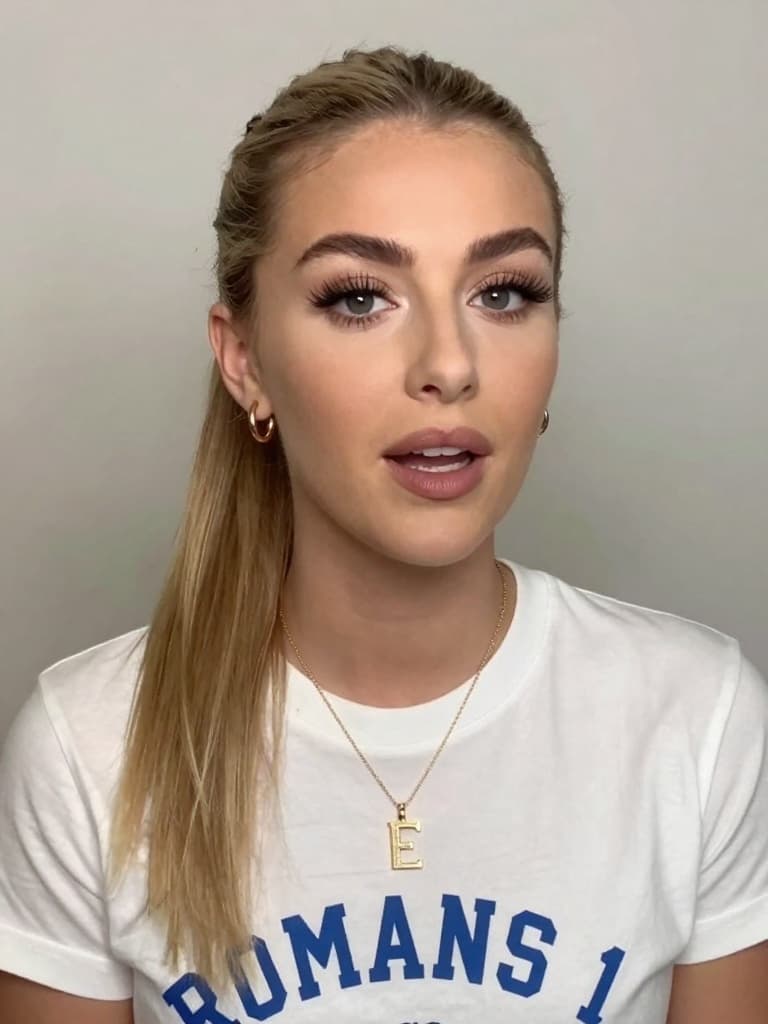 Video still from a smartphone camera of a conventionally attractive…