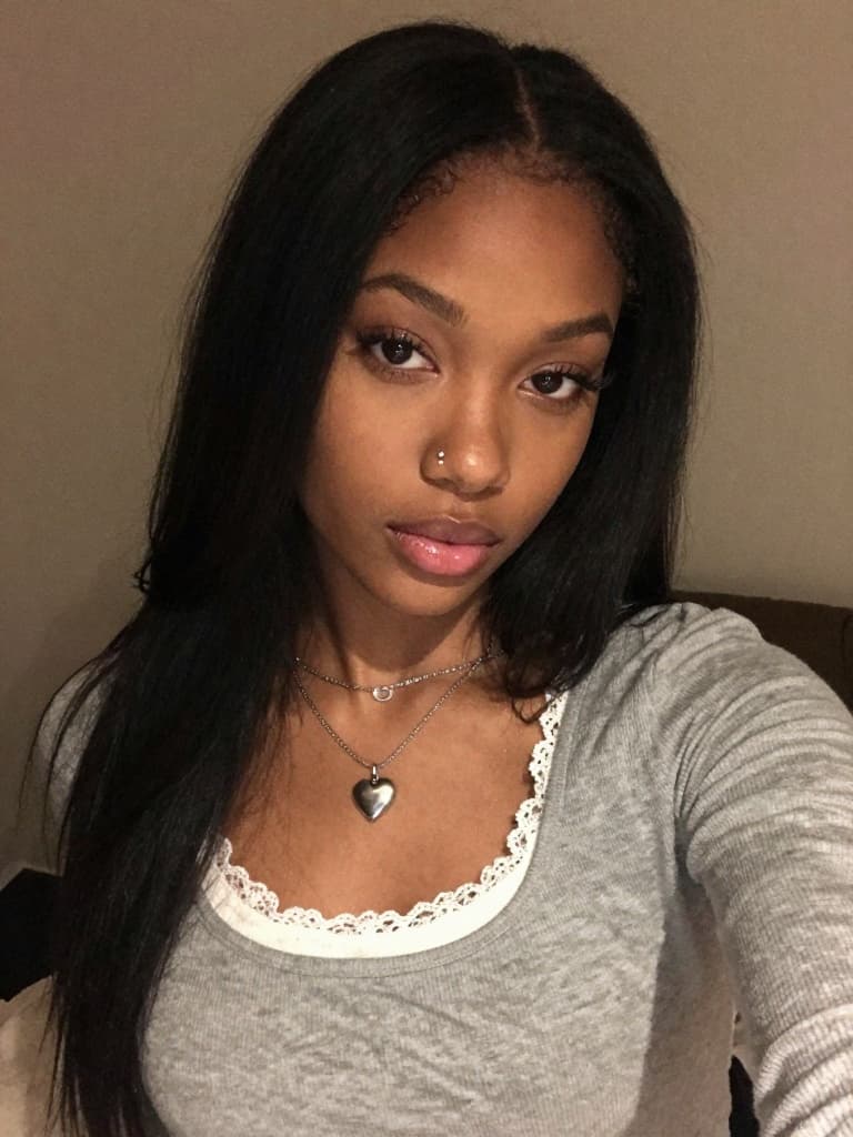 Smartphone selfie of a beautiful young black woman with long…