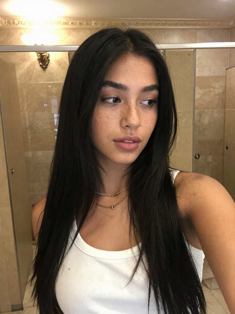 Smartphone selfie of a beautiful young hispanic woman with very long…