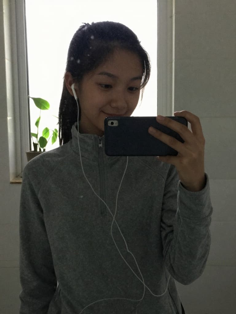 Mirror selfie taken on an older model smartphone by a teenage girl in…