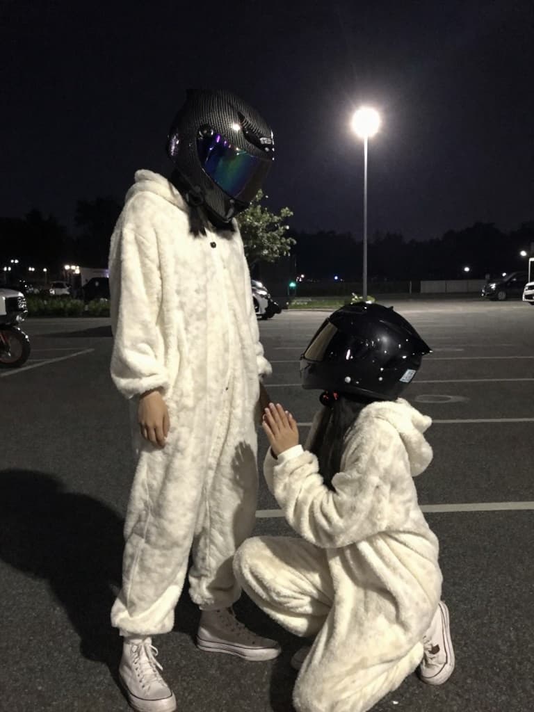 Video still from a smartphone, capturing two people in a parking lot…